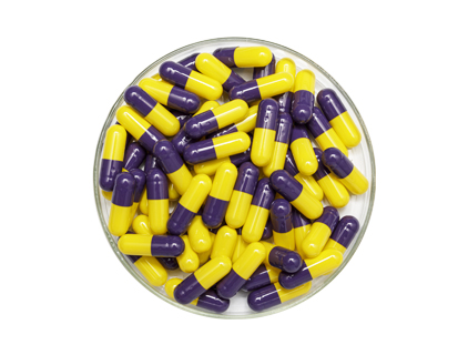 Dark purple cap and yellow core capsules